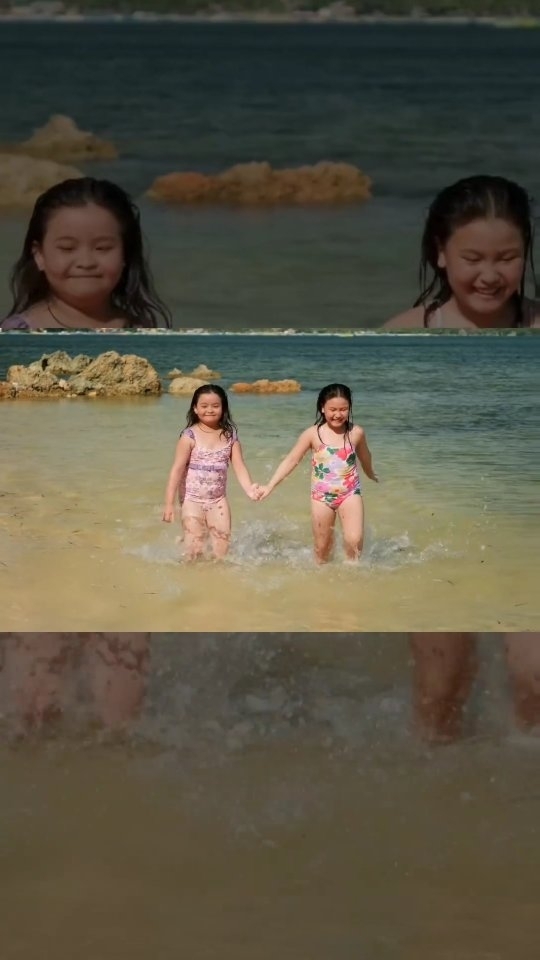 Two children holding hands and splashing on the private beach at Dasol Beach Villas